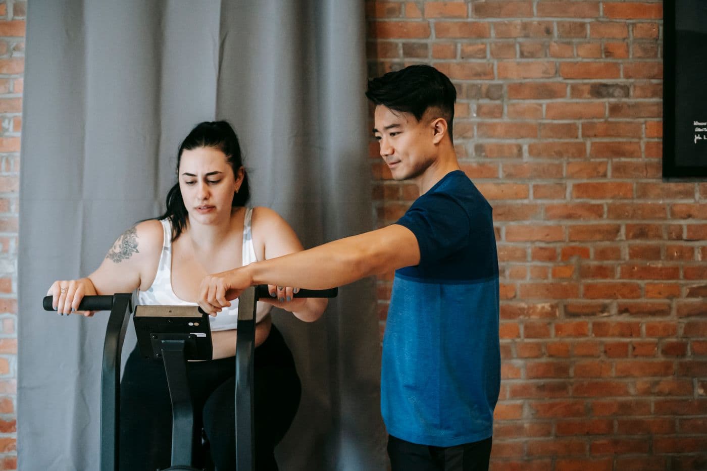 A trainer giving a member personal attention on the gym floor
